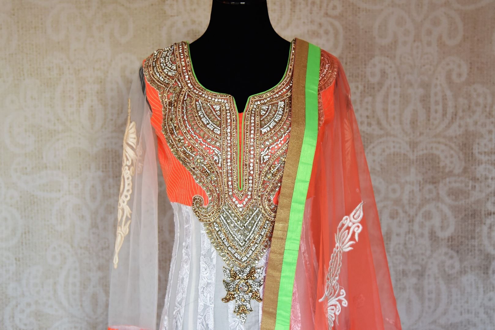 Buy white embroidered net floor length Anarkali suit online in USA with orange and green border from Pure Elegance. Choose from a range of exclusive Indian designer suits, wedding dresses, Anarkali suits in beautiful styles and designs from our Indian fashion store in USA and flaunt your tasteful sartorial choices on special occasions.-front