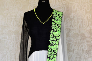 Shop black and white embroidered net floor length Anarkali suit online in USA with green border from Pure Elegance. Choose from a range of exclusive Indian designer suits, wedding dresses, Anarkali suits in beautiful styles and designs from our Indian fashion store in USA and flaunt your tasteful sartorial choices on special occasions.-front