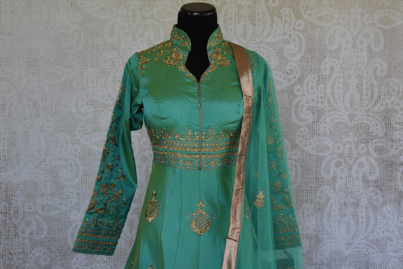 Green solid Suit with gold zari embroidery. Perfect suit for Indian parties and festivals.- neck style