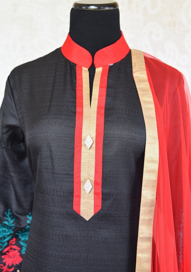 Shop black raw silk embroidered suit online in USA with red Dupatta. Shop ethnic Indian clothing for special occasions from Pure Elegance Indian fashion store in USA.-front