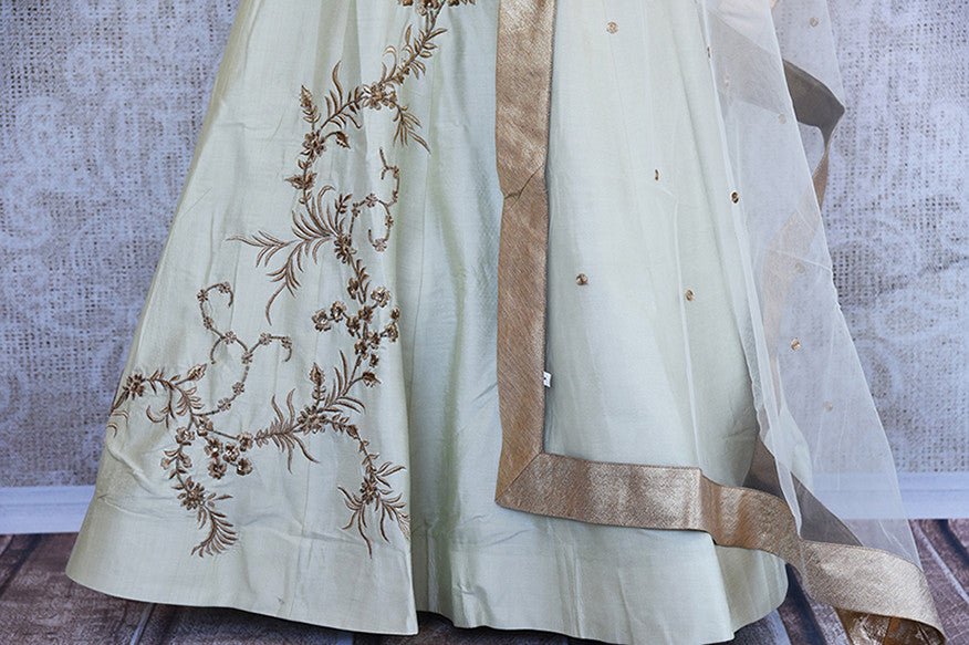 Off white silk embroidered anarkali with net dupatta. Classy addition in ethnic wardrobe.- lower view