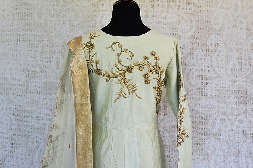Off white silk embroidered anarkali with net dupatta. Classy addition in ethnic wardrobe.-back