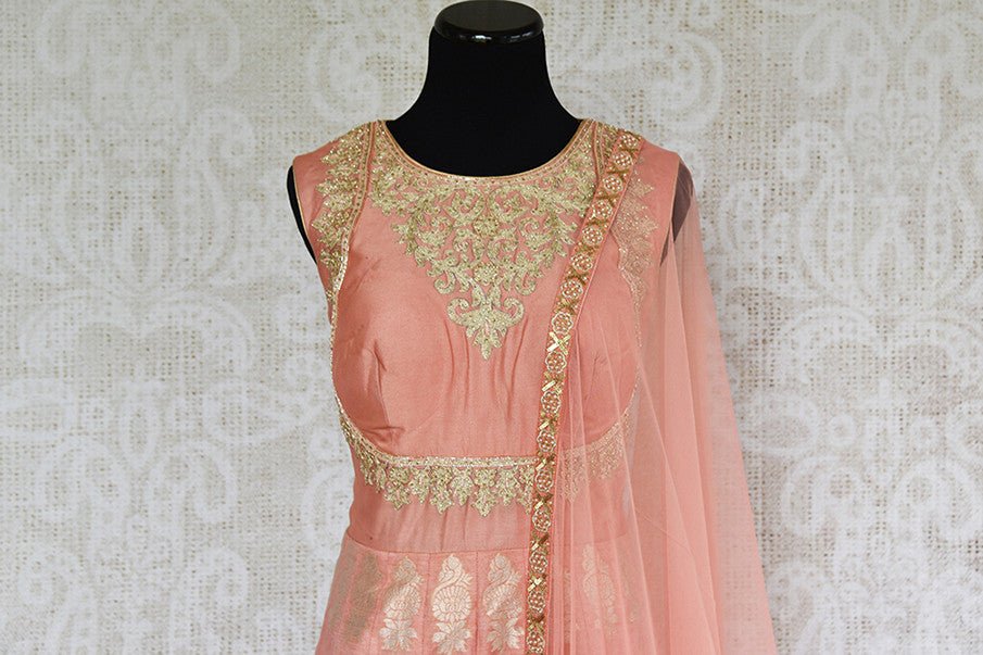 Designer Indian peach anarkali suit with gold embroidery. This comes with net dupatta . Party perfect.- embroidered top view