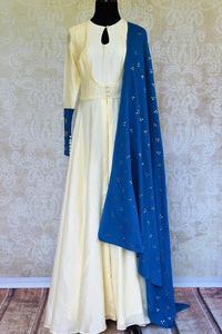 Buy off white silk Anarkali suit online in USA with blue dupatta. Pure Elegance fashion store brings a stunning range of Indian designer dresses in USA for every occasion.-full view