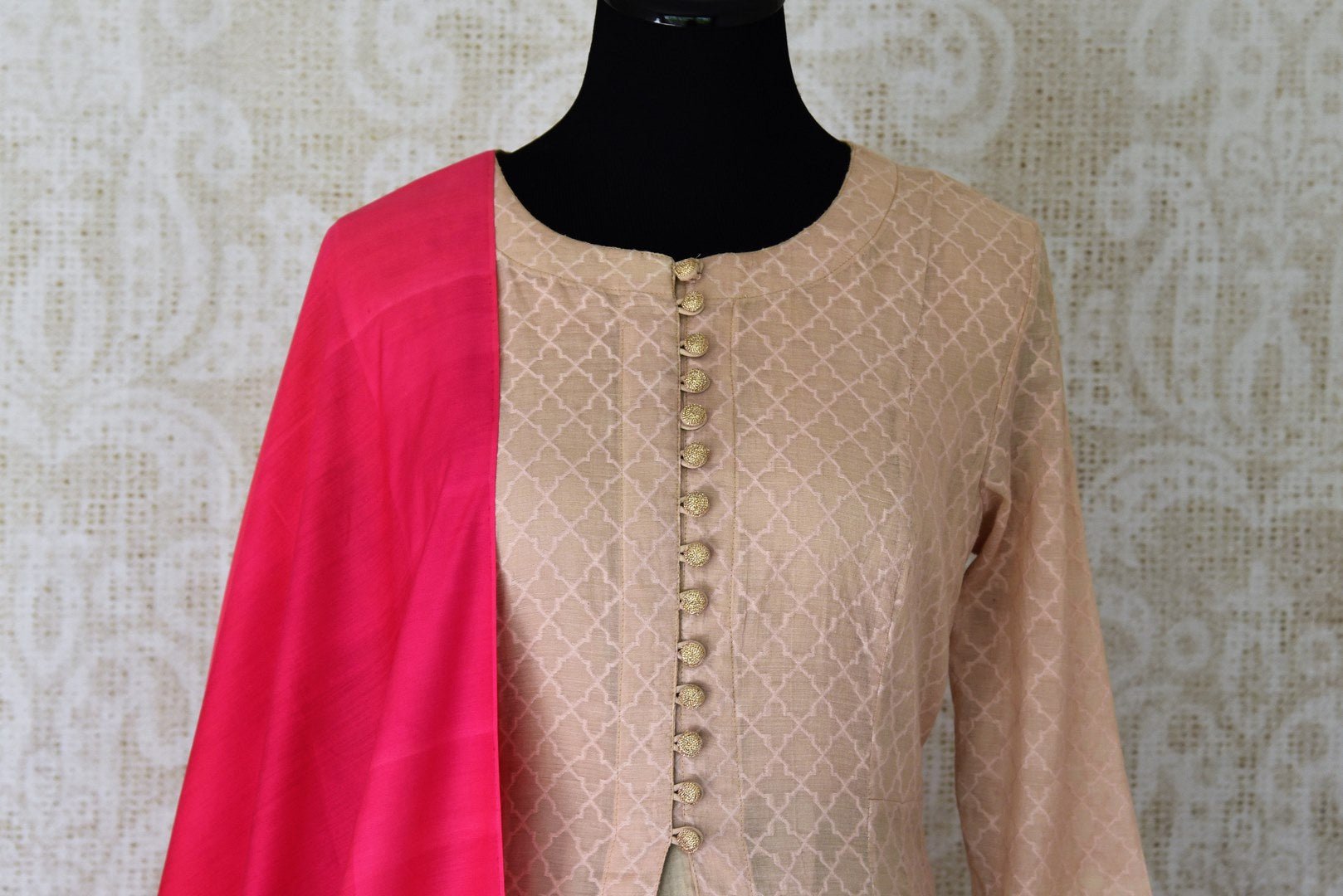 Sheer sophistication comes with muted tones and simplistic designs like this beige chanderi silk floor-length anarkali suit. The self-textured suit comes with a rich red silk dupatta to add oodles of charm. Shop designer salwar suits, lehenga sets, Indian dresses online or visit Pure Elegance store, USA.-kurta front