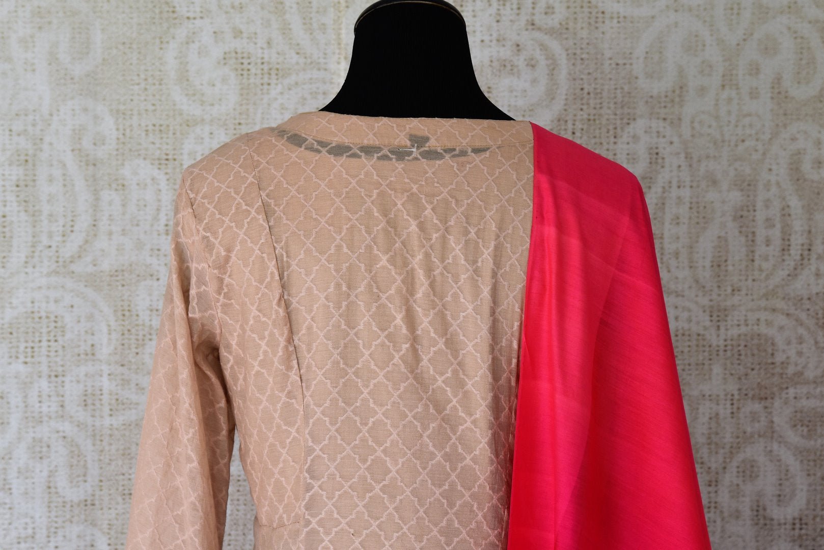 Sheer sophistication comes with muted tones and simplistic designs like this beige chanderi silk floor-length anarkali suit. The self-textured suit comes with a rich red silk dupatta to add oodles of charm. Shop designer salwar suits, lehenga sets, Indian dresses online or visit Pure Elegance store, USA.-kurta back