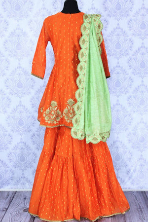 Bright orange embroidered sharara suit with dupatta for online shopping in USA. A beautiful choice for a striking ethnic Indian look at special occasions. Add latest Indian designer dresses to your ethnic wardrobe available at Pure Elegance Clothing store in USA for women.-back