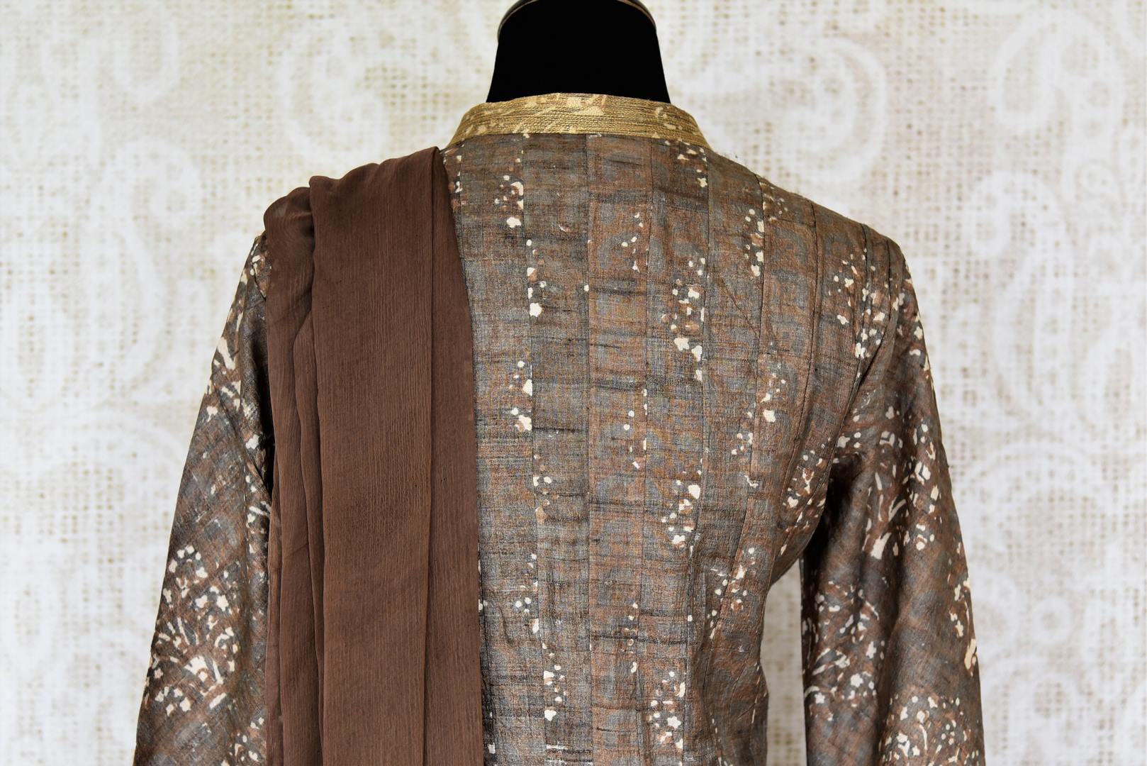 Buy brown printed tussar silk floor length Anarkali suit online in USA with dupatta. The elegant suit is perfect for a classic Indian ethnic look. Make your Indian clothing collection exquisite with beautiful Indian designer Anarkali suits available at Pure Elegance clothing store in USA or shop online.-suit back