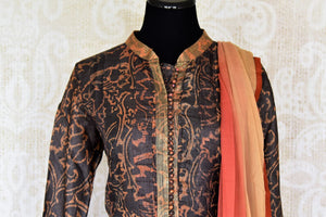 Buy dark brown printed tussar silk floor length Anarkali suit online in USA with dupatta. The elegant suit is perfect for a classic Indian ethnic look. Make your Indian clothing collection exquisite with beautiful Indian Anarkali suits available at Pure Elegance clothing store in USA or shop online.-suit front