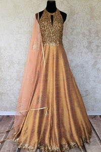 Leave them gaping in awe as you strut in this scintillating gold silk floor-length dress. The sequins embroidered on the dress complemented with a halter neck and peach sequin work dupatta looks spectacular Shop designer anarkali suits, concept sarees, indowestern dresses online or visit Pure Elegance store, USA. -full view