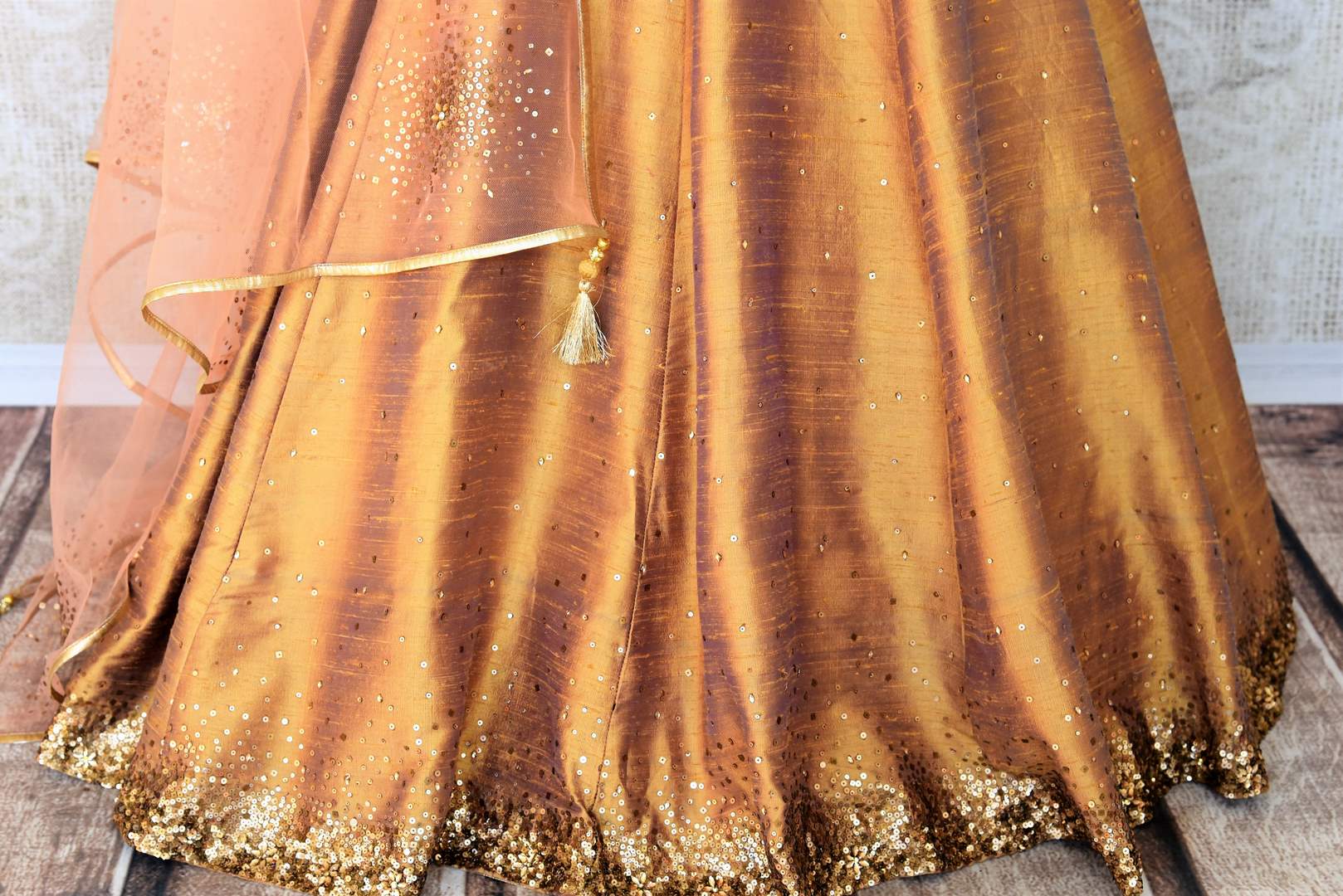 Leave them gaping in awe as you strut in this scintillating gold silk floor-length dress. The sequins embroidered on the dress complemented with a halter neck and peach sequin work dupatta looks spectacular Shop designer anarkali suits, concept sarees, indowestern dresses online or visit Pure Elegance store, USA. -pleats