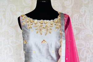 Be a muse in this pretty ash grey silk embroidered designer shararas with a dazzling grey embroidered kurta. The stunning zari embroidery coupled with a contrasting pink embellished dupatta with tassels hanging on its corners looks heavenly. Shop such beautiful Indian dresses, lehengas online or visit Pure Elegance store, USA. -suit front