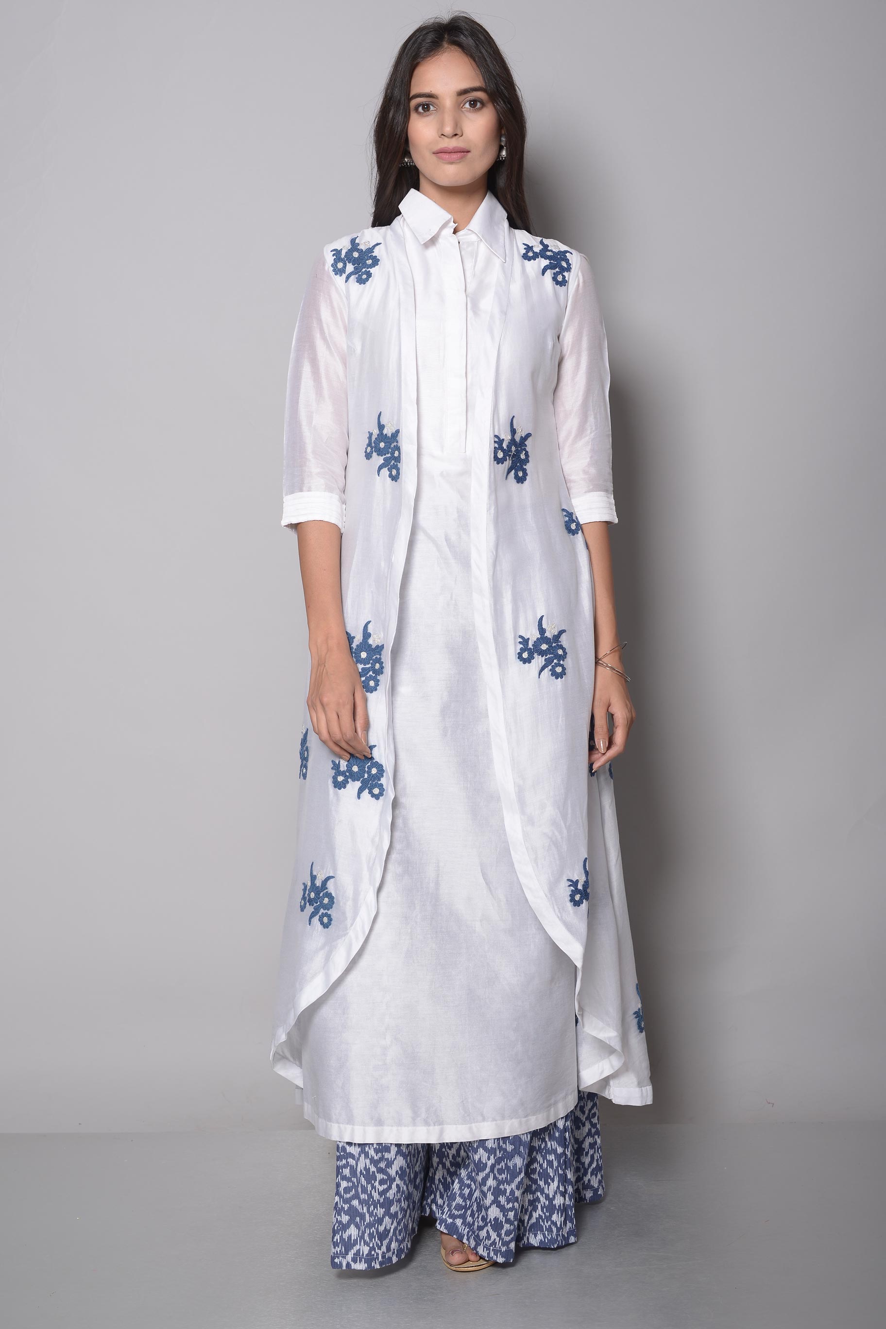 Buy white embroidered cape and kurta with palazzo online in USA. The cape is adorned with beautiful dori work motifs which makes it so captivating. To buy more such exquisite designer suits in USA, shop at Pure Elegance Indian clothing store in USA or shop online.-full view