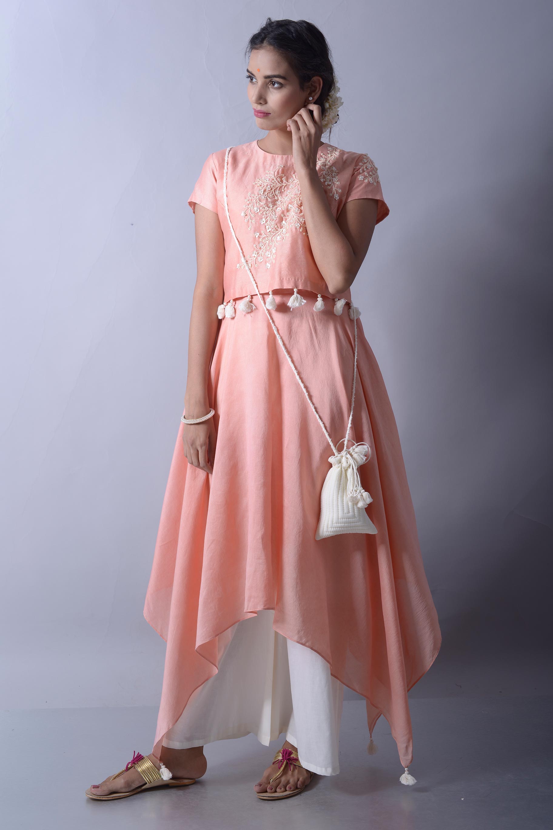 Buy salmon peach handkerchief kurta and crop top with palazzo online in USA. The crop top is embellished with beautiful dori work which makes it absolutely alluring. To buy more such exquisite Indian designer suits in USA, shop at Pure Elegance Indian clothing store in USA or shop online.-full view