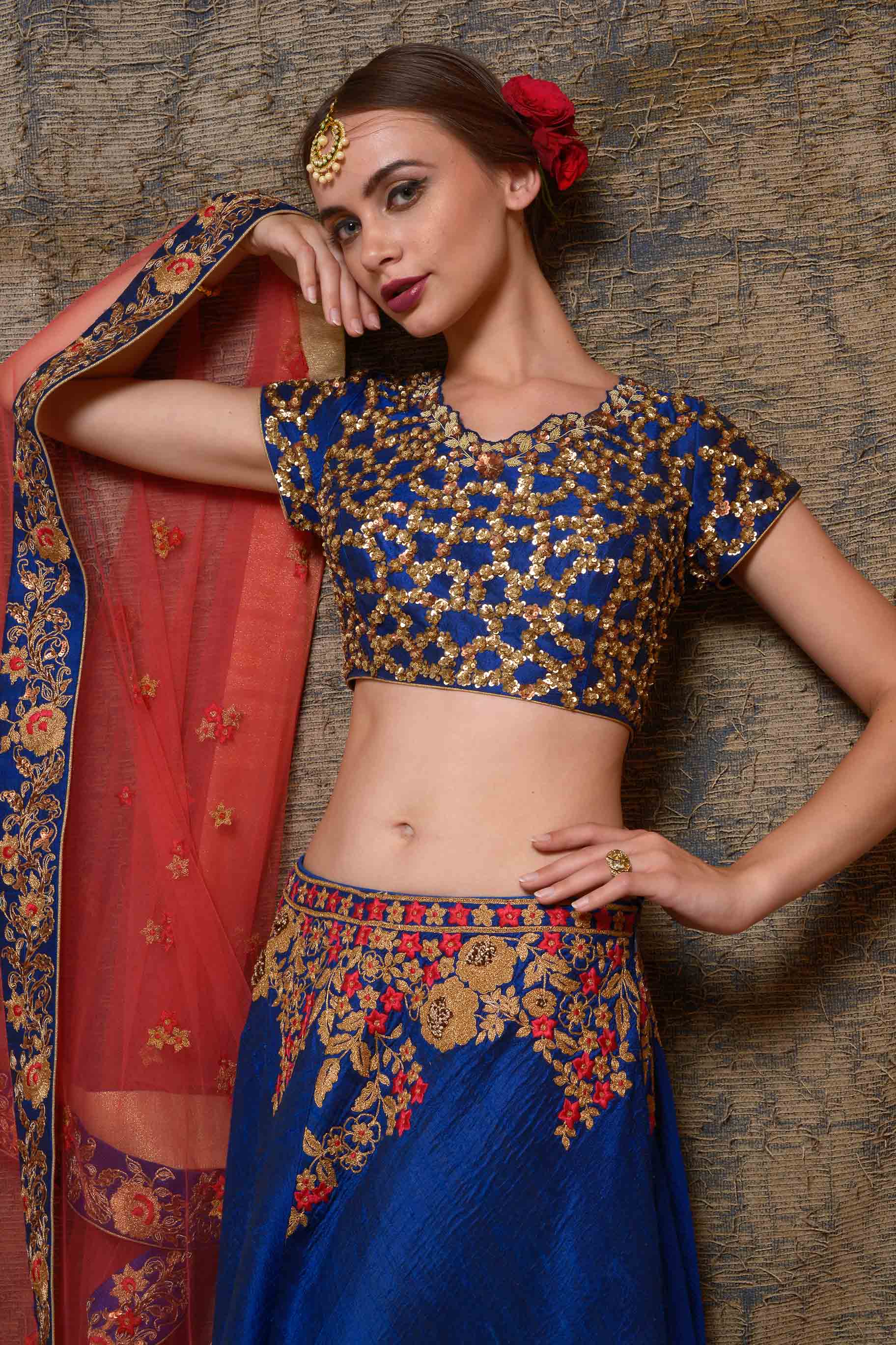 Buy blue raw silk embroidered lehenga online in USA with red net dupatta. Shine in rich silhouettes of exquisite Indian designer wedding lehengas from Pure Elegance Indian clothing store for women in USA or shop online.-blouse