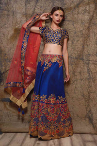 Buy blue raw silk embroidered lehenga online in USA with red net dupatta. Shine in rich silhouettes of exquisite Indian designer wedding lehengas from Pure Elegance Indian clothing store for women in USA or shop online.-full view