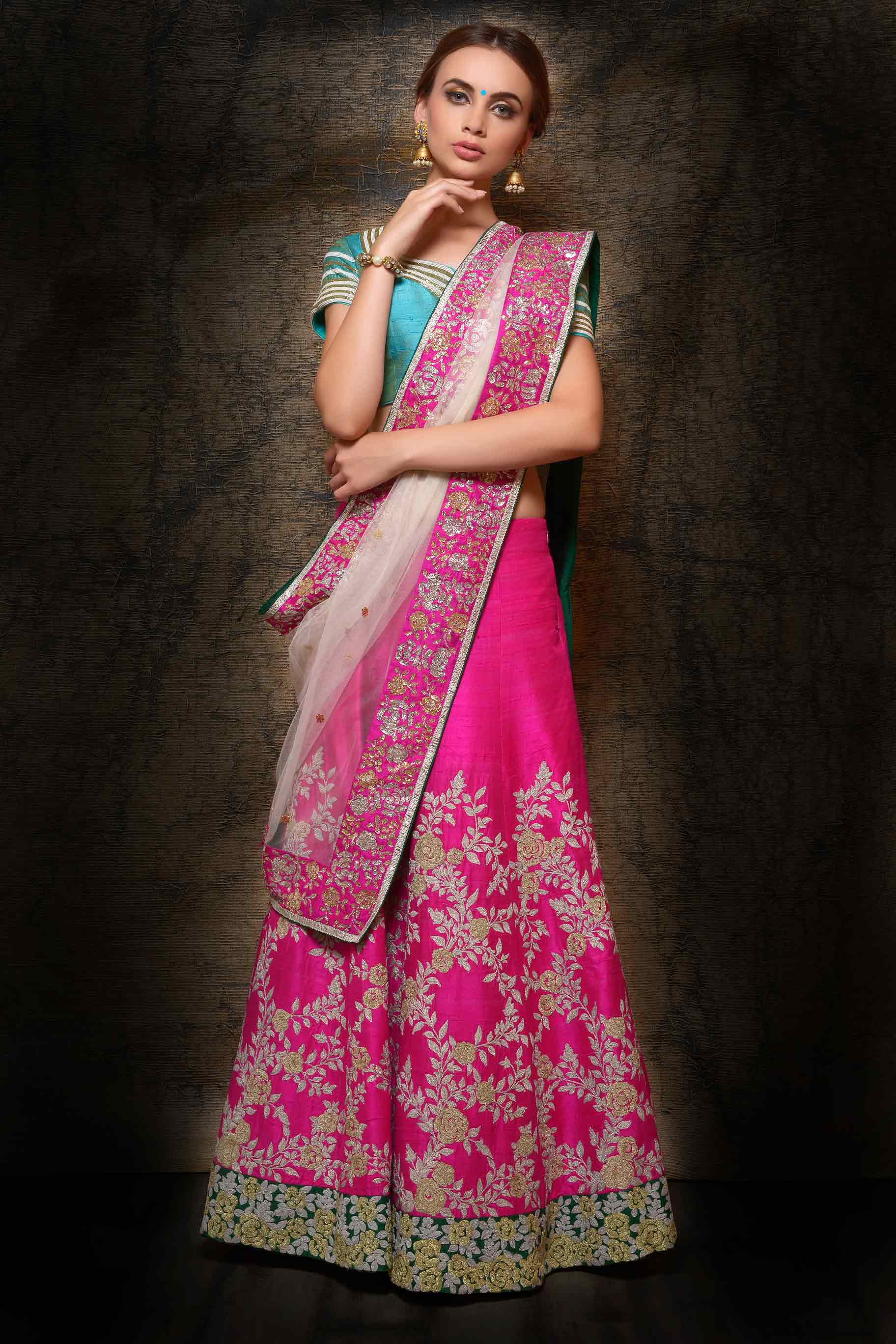 Buy hot pink raw silk embroidered lehenga online in USA with blue choli. Shine in rich silhouettes of exquisite Indian designer wedding lehengas from Pure Elegance Indian clothing store for women in USA or shop online.-full view