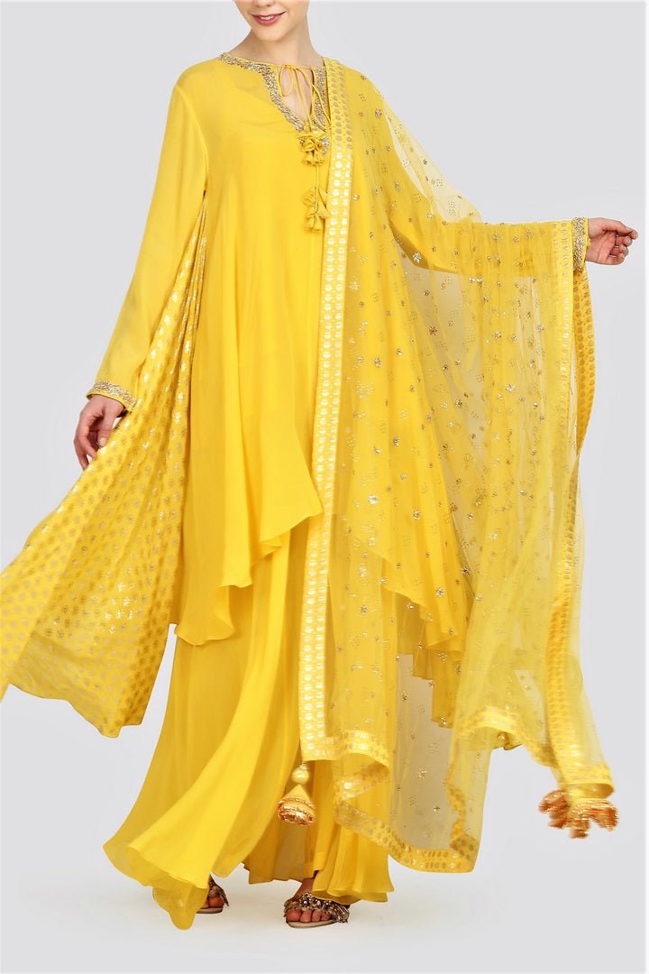 Buy yellow foil print asymmetric kurta with sharara online in USA and net dupatta. For more such gorgeous designer dresses, shop at Pure Elegance Indian fashion store in USA. A beautiful range of traditional Indian sarees and designer clothing is available for Indian women living in USA. You can also shop at our online store.-full view