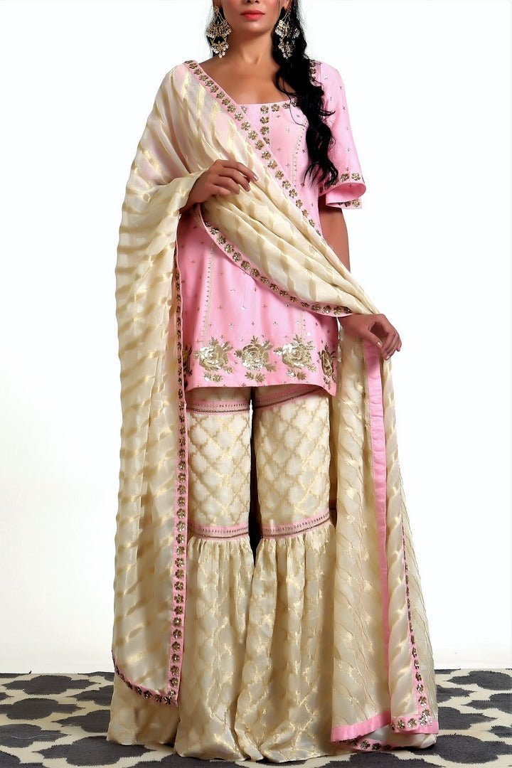 Buy blush pink short kurta with ivory tissue net garara and dupatta online in USA. Get occasion ready with a stunning range of Indian designer suits from Pure Elegance fashion store in USA. We bring the best designer dresses for Indian women in USA at our online store. Shop now.-full view