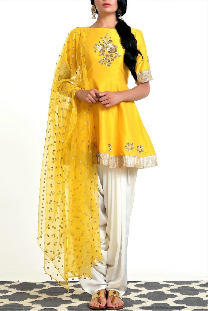 Buy yellow silk blend peplum kurta with white dhoti salwar and net dupatta online in USA. Get occasion ready with a stunning range of Indian designer suits from Pure Elegance fashion store in USA. We bring the best designer dresses for Indian women in USA at our online store. Shop now.-full view