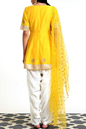 Buy yellow silk blend peplum kurta with white dhoti salwar and net dupatta online in USA. Get occasion ready with a stunning range of Indian designer suits from Pure Elegance fashion store in USA. We bring the best designer dresses for Indian women in USA at our online store. Shop now.-back