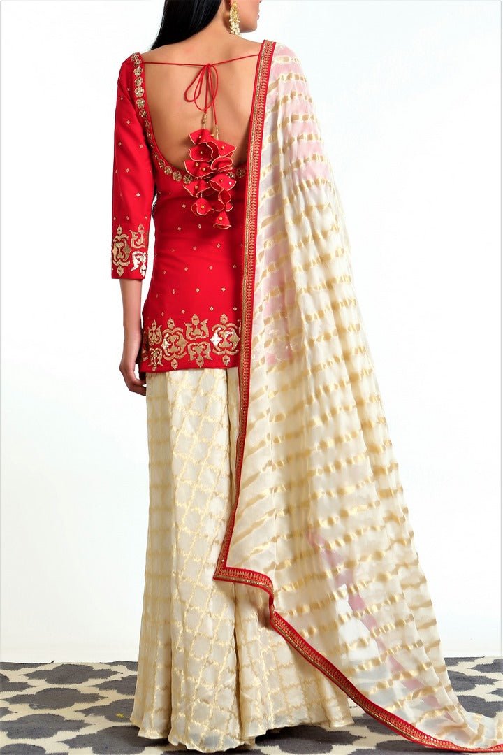 Buy crimson red silk blend short kurta with gold tissue net gharara online in USA. Get occasion ready with a stunning range of Indian designer suits from Pure Elegance fashion store in USA. We bring the best designer dresses for Indian women in USA at our online store. Shop now.-back