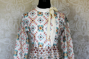 Shop elegant white silk Anarkali dress online in USA with mirror work. Make your party style absolutely special with beautiful Indian designer suits from Pure Elegance Indian fashion store in USA. Get floored with a range of beautiful Anarkali suits, designer lehengas, Indian dresses all under one roof for Indian women in USA.-front