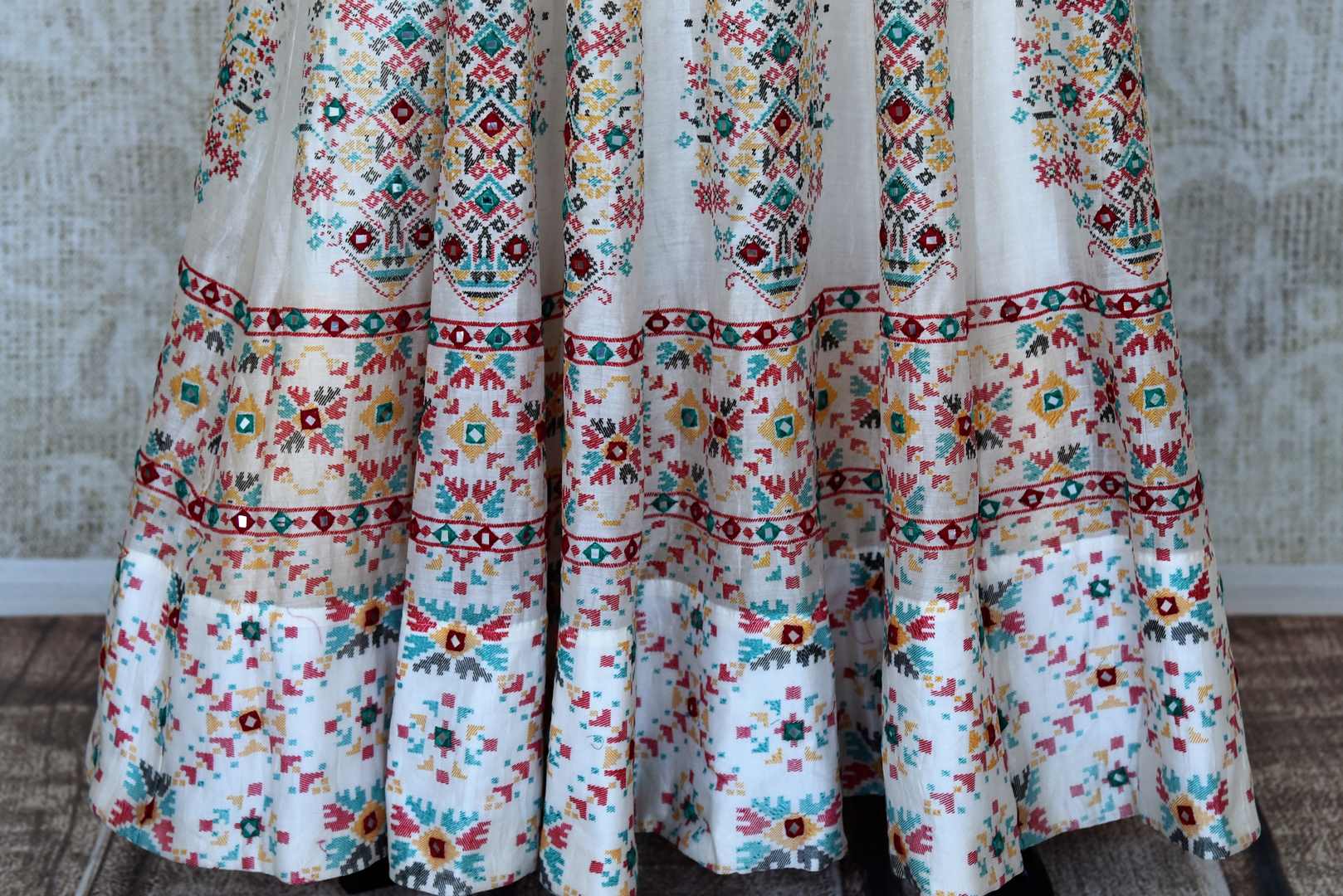 Shop elegant white silk Anarkali dress online in USA with mirror work. Make your party style absolutely special with beautiful Indian designer suits from Pure Elegance Indian fashion store in USA. Get floored with a range of beautiful Anarkali suits, designer lehengas, Indian dresses all under one roof for Indian women in USA.-bottom