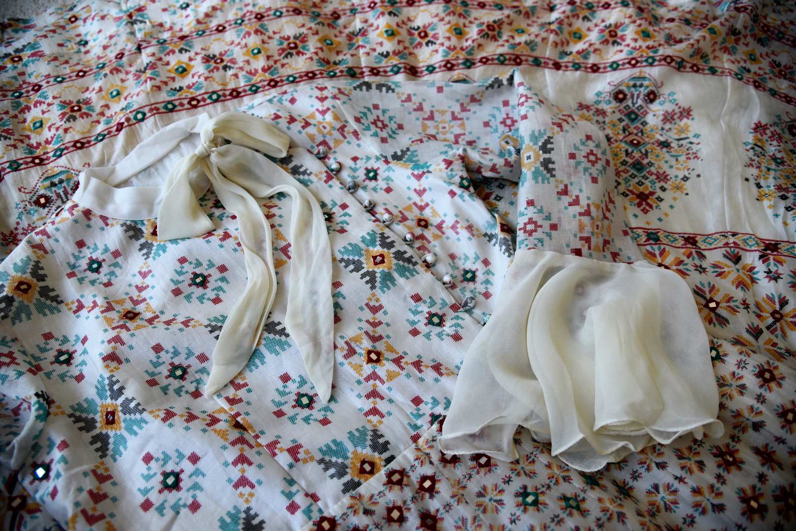 Shop elegant white silk Anarkali dress online in USA with mirror work. Make your party style absolutely special with beautiful Indian designer suits from Pure Elegance Indian fashion store in USA. Get floored with a range of beautiful Anarkali suits, designer lehengas, Indian dresses all under one roof for Indian women in USA.-details