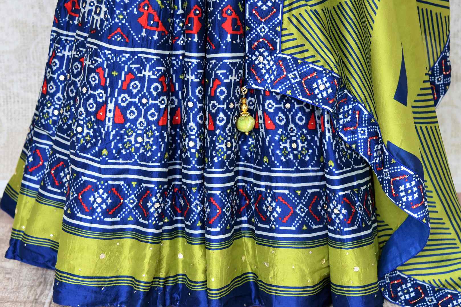Buy blue hand work ikat silk Anarkali suit online in USA with green dupatta. Be the talk of weddings and special occasions with a splendid collection of Indian designer suits from Pure Elegance Indian clothing store in USA. We have a spectacular range of designer dresses, bridal lehengas for Indian brides in USA.-bottom