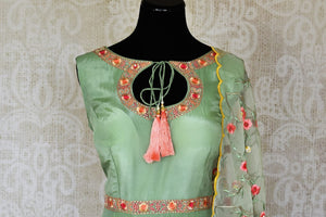 Shop green embroidered sleeveless silk Anarkali online in USA with dupatta. Pick your favorite Indian clothing from a colorful collection available at Pure Elegance Indian fashion store in USA. We have an alluring range of wedding lehengas, designer Anarkali suits, gowns for Indian women in USA.-front
