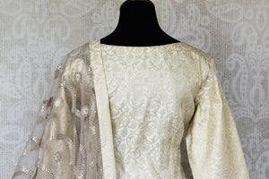 Shop cream embroidered Banarasi silk suit online in USA with grey silk sharara. Keep your wardrobe update with latest Indian clothing from Pure Elegance Indian fashion store in USA. Shop beautiful Indian designer lehengas, Anarkali suits, gowns for Indian women in USA from our online store.-back