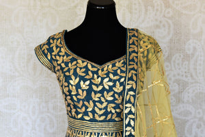Buy teal blue lace applique silk Anarkali suit online in USA with yellow dupatta. Keep your wardrobe update with latest Indian clothing from Pure Elegance Indian fashion store in USA. Shop beautiful Indian designer lehengas, Anarkali suits, gowns for Indian women in USA from our online store.-front