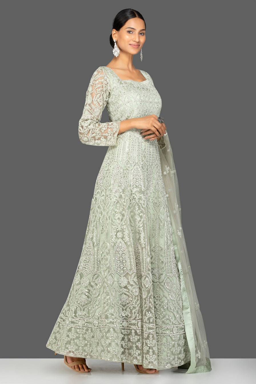 Shop grey stone and resham embroidery net Anarkali online in USA with dupatta. Make a stunning fashion statement at weddings and special occasions with an exquisite collection of designer Anarkali suits, traditional salwar suits, bridal lehengas from Pure Elegance Indian fashion store in USA. -side pose