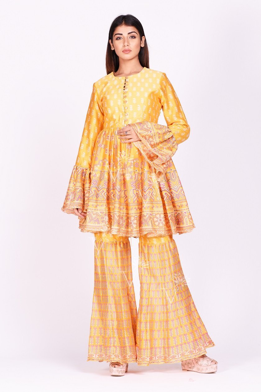 Shop contemporary yellow printed silk sharara set online in USA. Make a stunning fashion statement at weddings and special occasions with an exquisite collection of designer Anarkali suits, traditional salwar suits, designer lehengas from Pure Elegance Indian fashion store in USA. -front