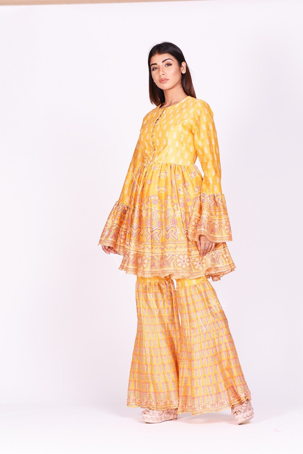 Shop contemporary yellow printed silk sharara set online in USA. Make a stunning fashion statement at weddings and special occasions with an exquisite collection of designer Anarkali suits, traditional salwar suits, designer lehengas from Pure Elegance Indian fashion store in USA. -side