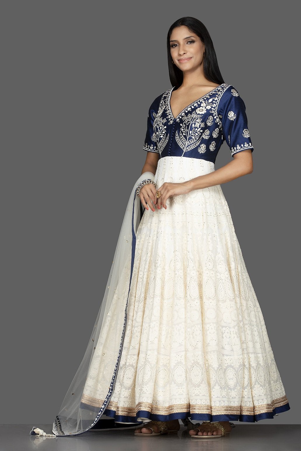 Buy beautiful off-white and blue Lucknowi work georgette Anarkali suit online in USA with dupatta. Spread ethnic elegance on weddings and special occasions in splendid designer lehengas, Anarkali suits crafted with exquisite Indian craftsmanship from Pure Elegance Indian fashion store in USA.-side