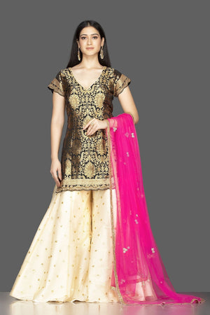 Buy gorgeous black and cream embroidered net and Banarasi sharara suit online in USA with pink dupatta. Spread ethnic elegance on weddings and special occasions in splendid designer lehengas, Anarkali suits crafted with exquisite Indian craftsmanship from Pure Elegance Indian fashion store in USA.-front