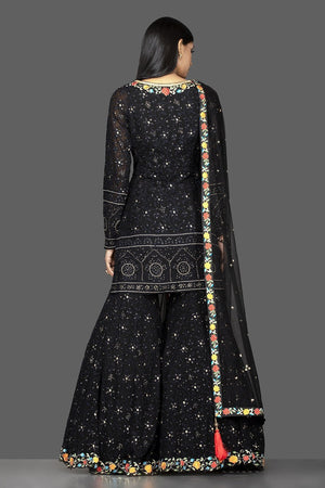 Buy stunning black georgette Lucknowi work garara suit online in USA with dupatta. Spread ethnic elegance on weddings and special occasions in splendid designer lehengas, Anarkali suits crafted with exquisite Indian craftsmanship from Pure Elegance Indian fashion store in USA.-back