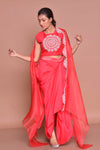 Buy red embroidered crop top online in USA with draped skirt and cape. Get ready for festive occasions with exquisite designer dresses, salwar suits, sharara suits  from Pure Elegance Indian clothing store in USA.-full view