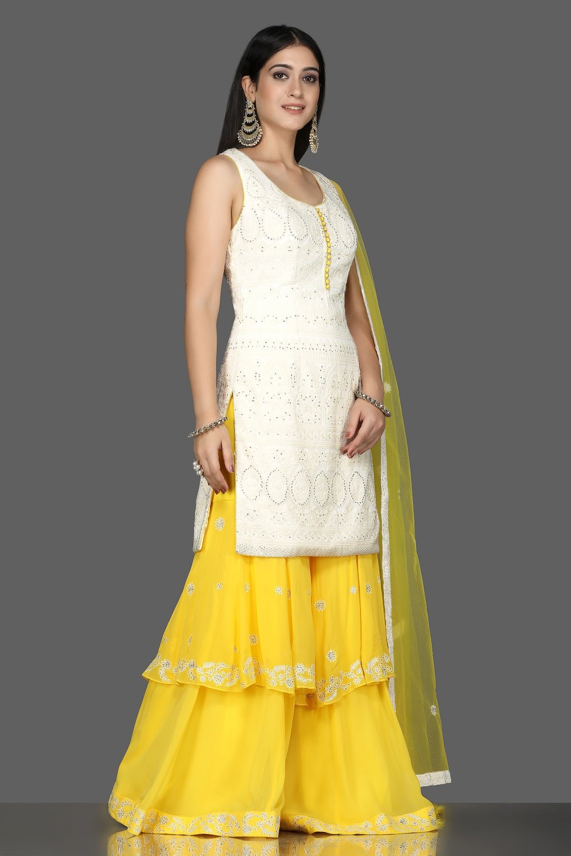 Shop white Lucknowi kurta online in USA with yellow georgette sharara. Flaunt ethnic fashion with exquisite designer lehenga, Indian wedding dresses, Anarkali suits from Pure Elegance Indian fashion boutique in USA.-side