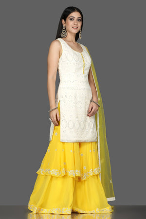 Shop white Lucknowi kurta online in USA with yellow georgette sharara. Flaunt ethnic fashion with exquisite designer lehenga, Indian wedding dresses, Anarkali suits from Pure Elegance Indian fashion boutique in USA.-side