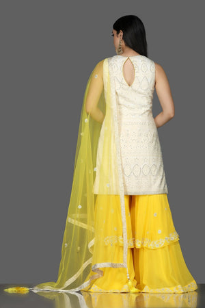Shop white Lucknowi kurta online in USA with yellow georgette sharara. Flaunt ethnic fashion with exquisite designer lehenga, Indian wedding dresses, Anarkali suits from Pure Elegance Indian fashion boutique in USA.-back