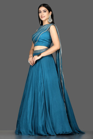 Buy blue embroidered silk lehenga online in USA with draped dupatta. Flaunt your extraordinary fashion sense with stunning Indian dresses, designer lehenga from Pure Elegance Indian fashion store in USA.-side