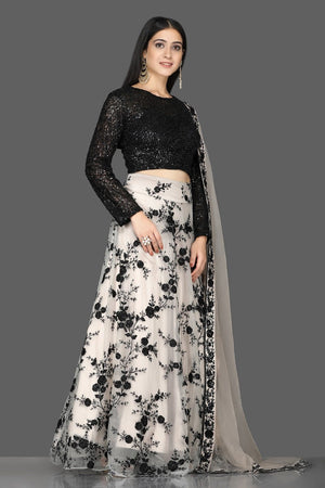 Shop stunning black sequin blouse with embroidered net skirt online in USA and dupatta. Flaunt your extraordinary fashion sense with stunning Indian dresses, designer lehenga from Pure Elegance Indian fashion store in USA.-side
