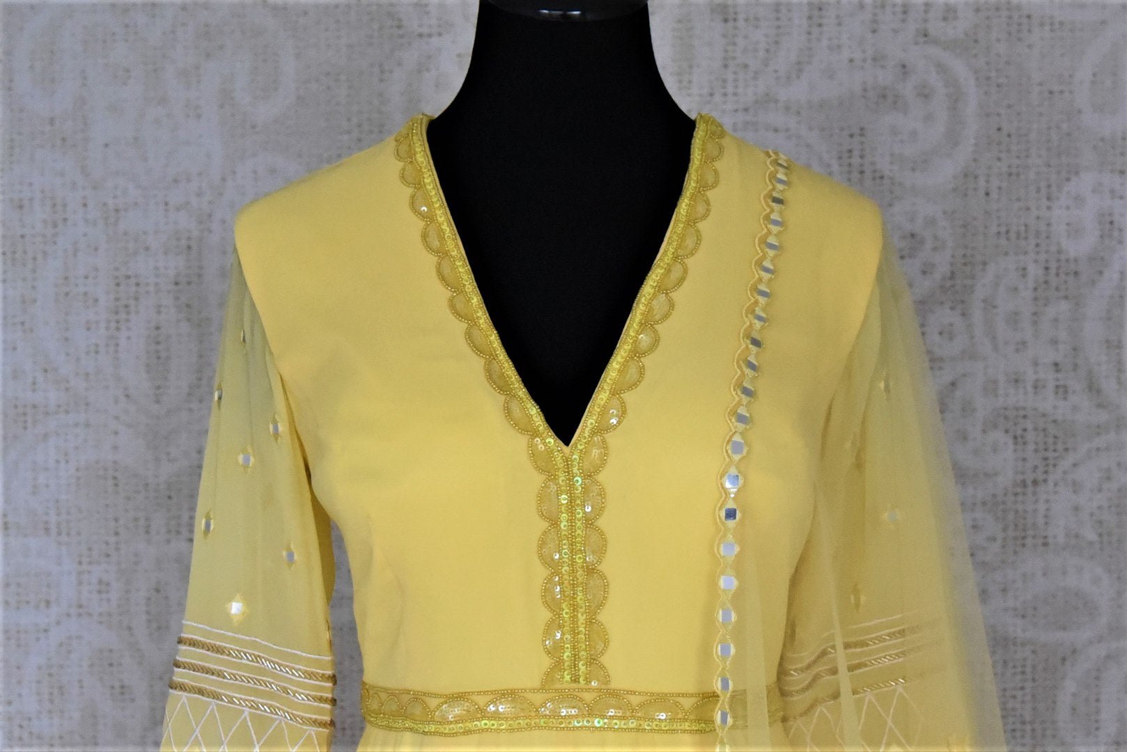 Buy stunning yellow hand embroidered georgette Anarkali online in USA with dupatta. Dazzle at weddings and festive occasions with stunning designer sharara and Anarkali suits from Pure Elegance Indian fashion store in USA.-front