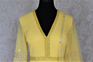 Buy stunning yellow hand embroidered georgette Anarkali online in USA with dupatta. Dazzle at weddings and festive occasions with stunning designer sharara and Anarkali suits from Pure Elegance Indian fashion store in USA.-front