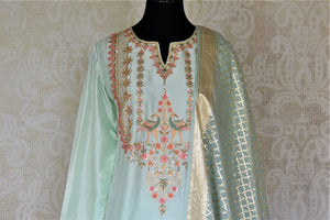 Shop exquisite mint green hand embroidery silk suit with palazzo online in USA and dupatta. Dazzle at weddings and festive occasions with stunning designer sharara and Anarkali suits from Pure Elegance Indian fashion store in USA.-front
