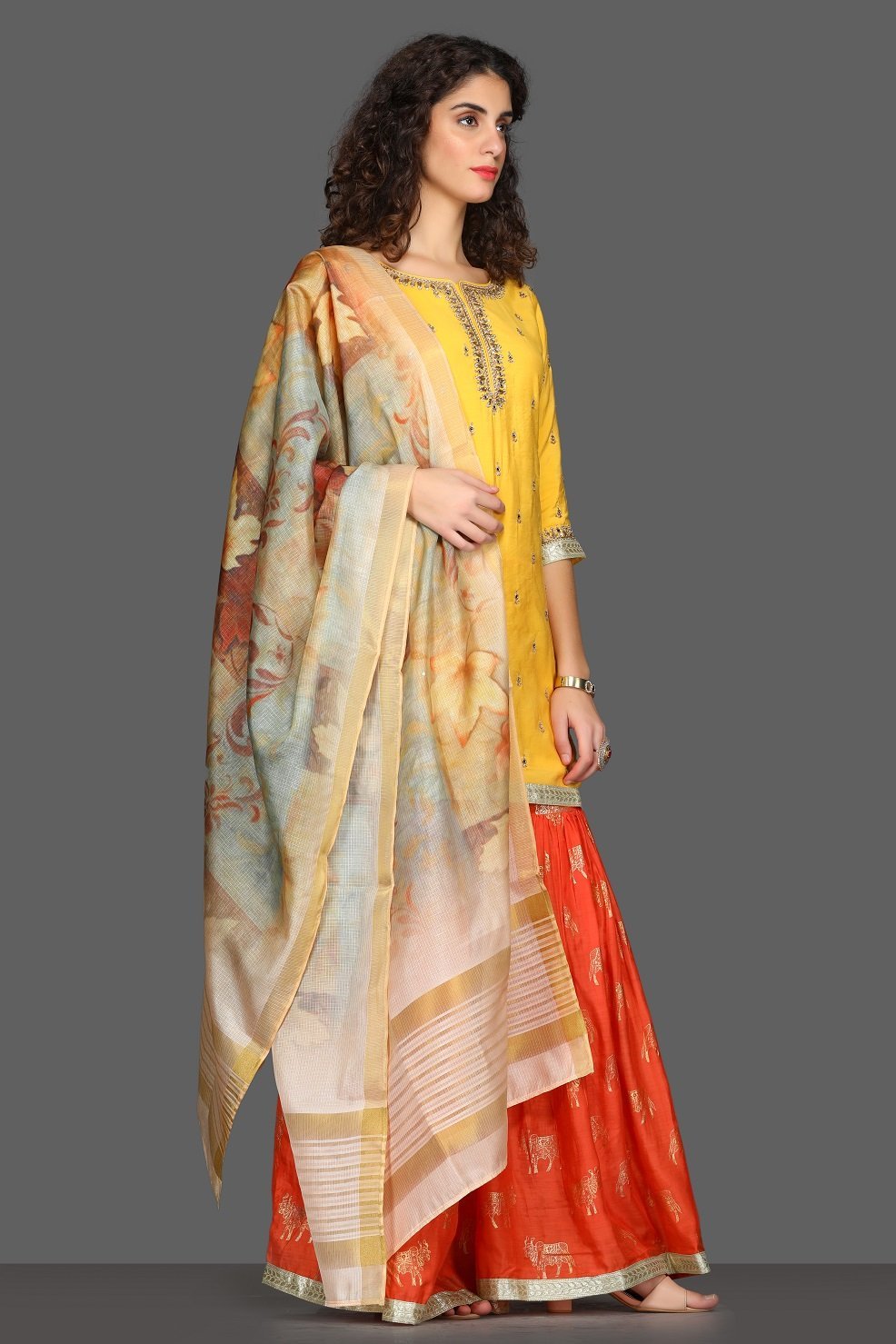 Buy bright yellow and red embroidered sharara suit online in USA with printed dupatta. Dazzle on weddings and special occasions with exquisite Indian designer dresses, sharara suits, Anarkali suits from Pure Elegance Indian fashion store in USA.-side