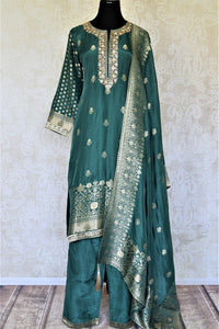 Shop dark green embroidered silk palazzo suit online in USA with dupatta. Elevate your ethnic style on weddings and festive occasions with stunning designer Anarkali suits, sharara suits, palazzo suits, salwar suits from Pure Elegance Indian fashion boutique in USA.-full view
